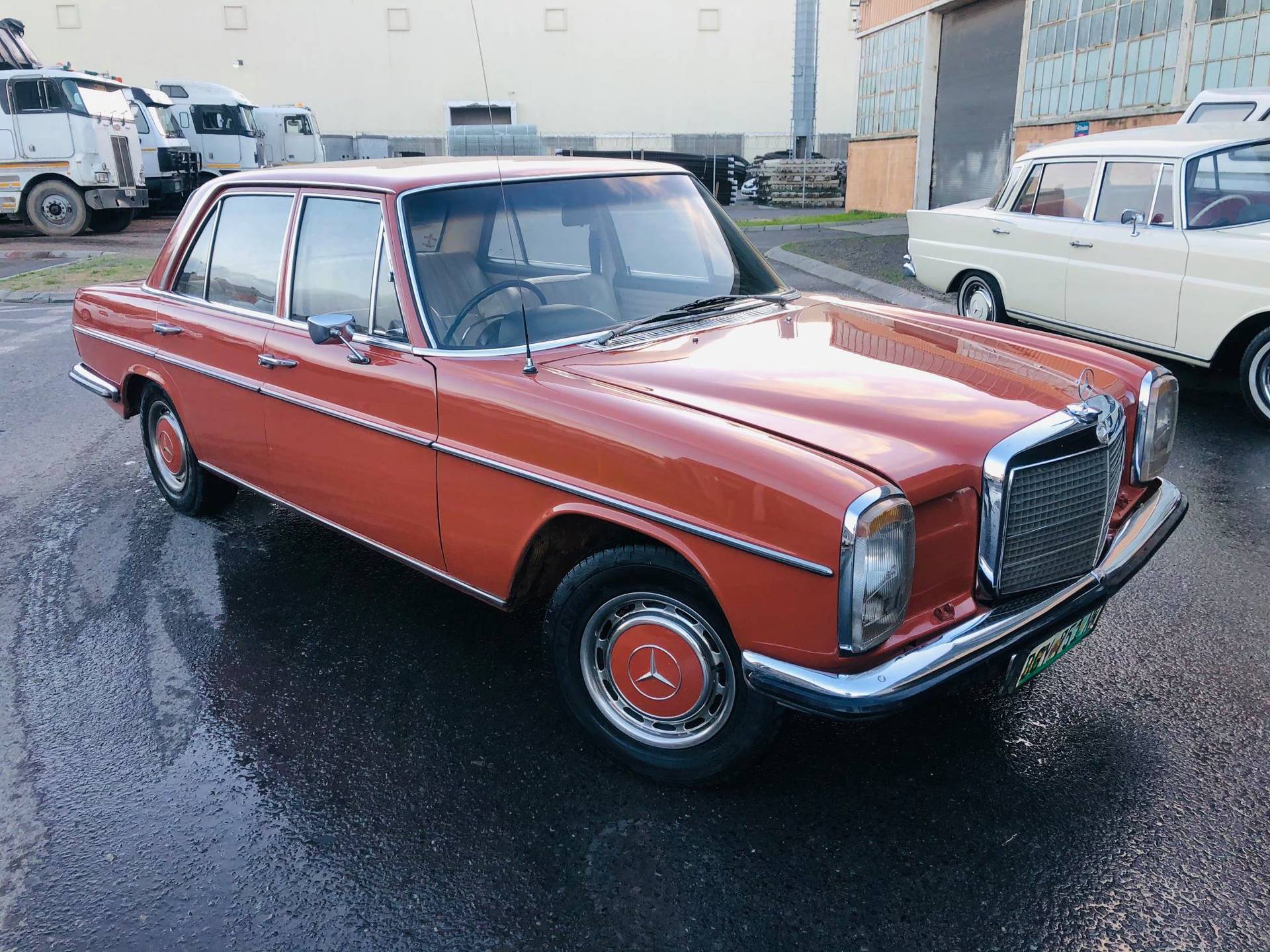 Classic Mercedes-Benz vehicles showcased in a vintage warehouse
