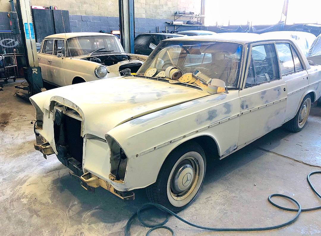 Classic Mercedes-Benz elevated in a car workshop